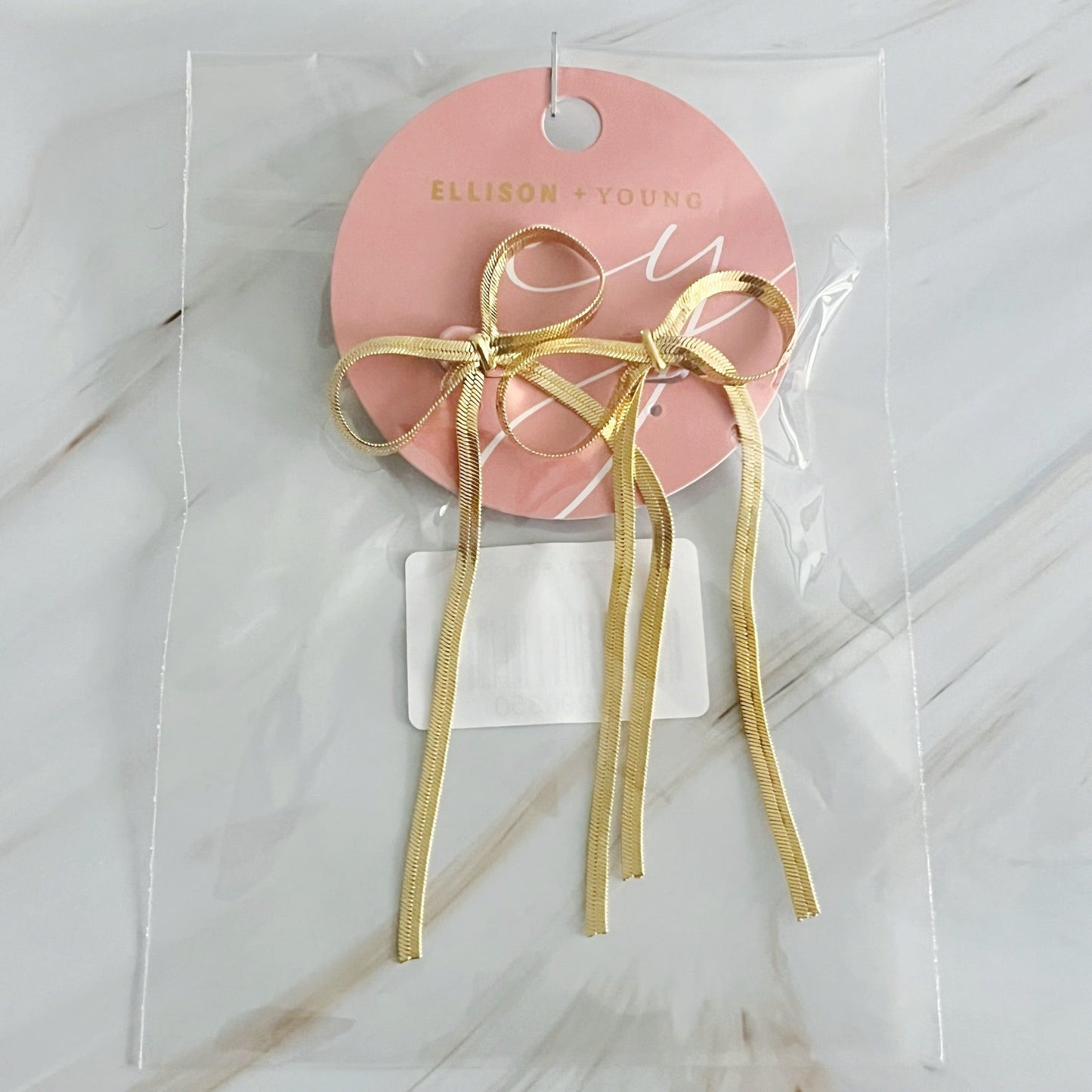 Stylish long drop bow earrings in gold, designed to enhance any outfit with a modern touch. Size: 1.5" x 3".