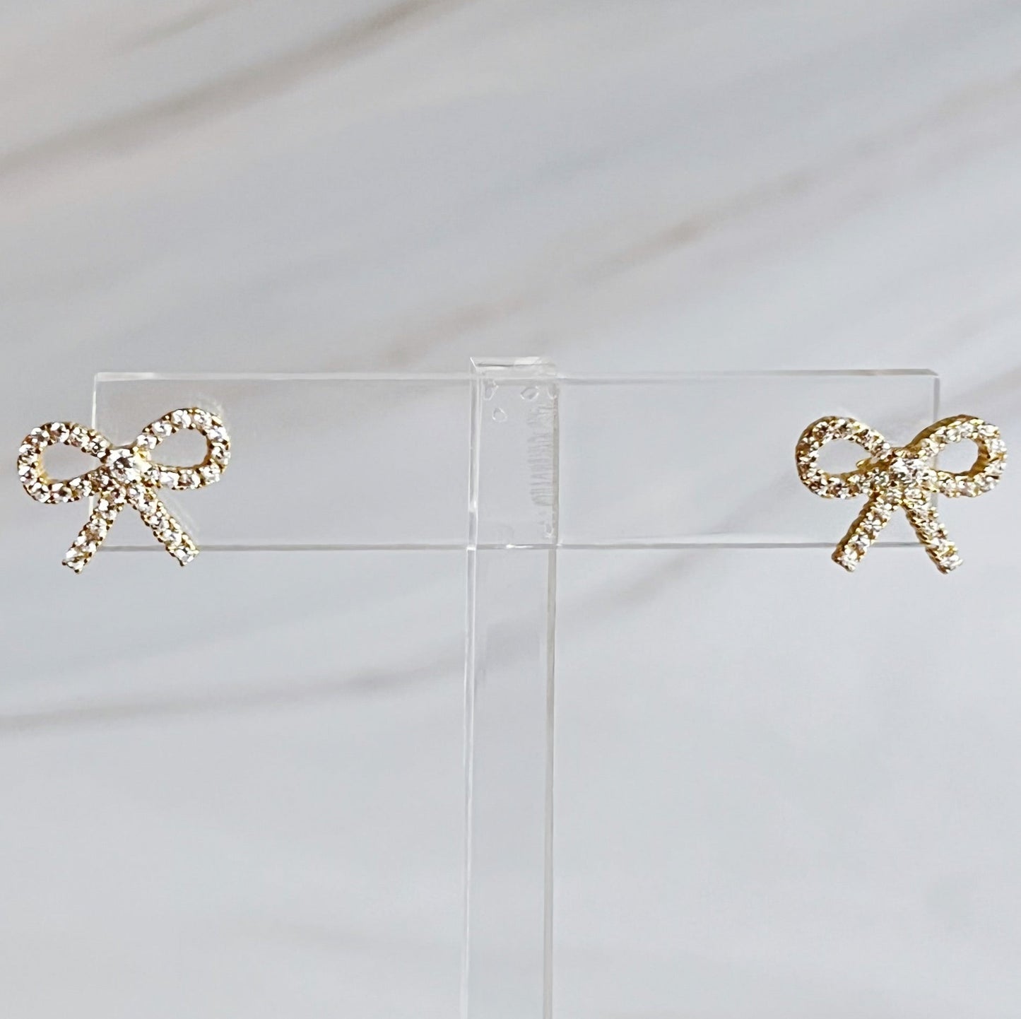 Shine Mini Bow Earrings in gold and crystal, crafted from sterling silver, perfect for elevating any outfit's style
