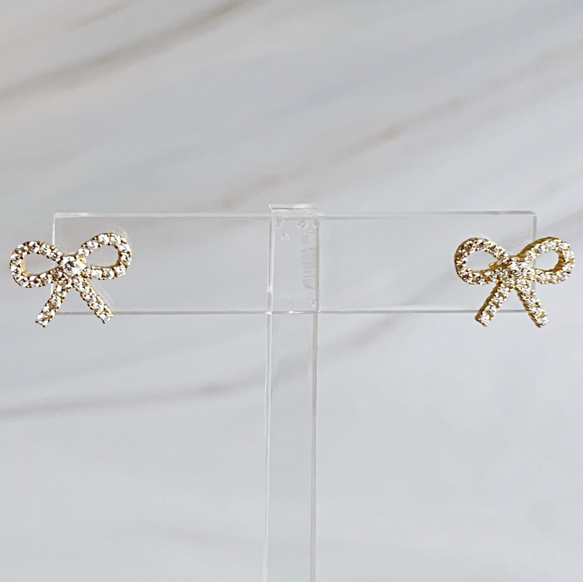 Shine Mini Bow Earrings in gold and crystal, crafted from sterling silver, perfect for elevating any outfit's style
