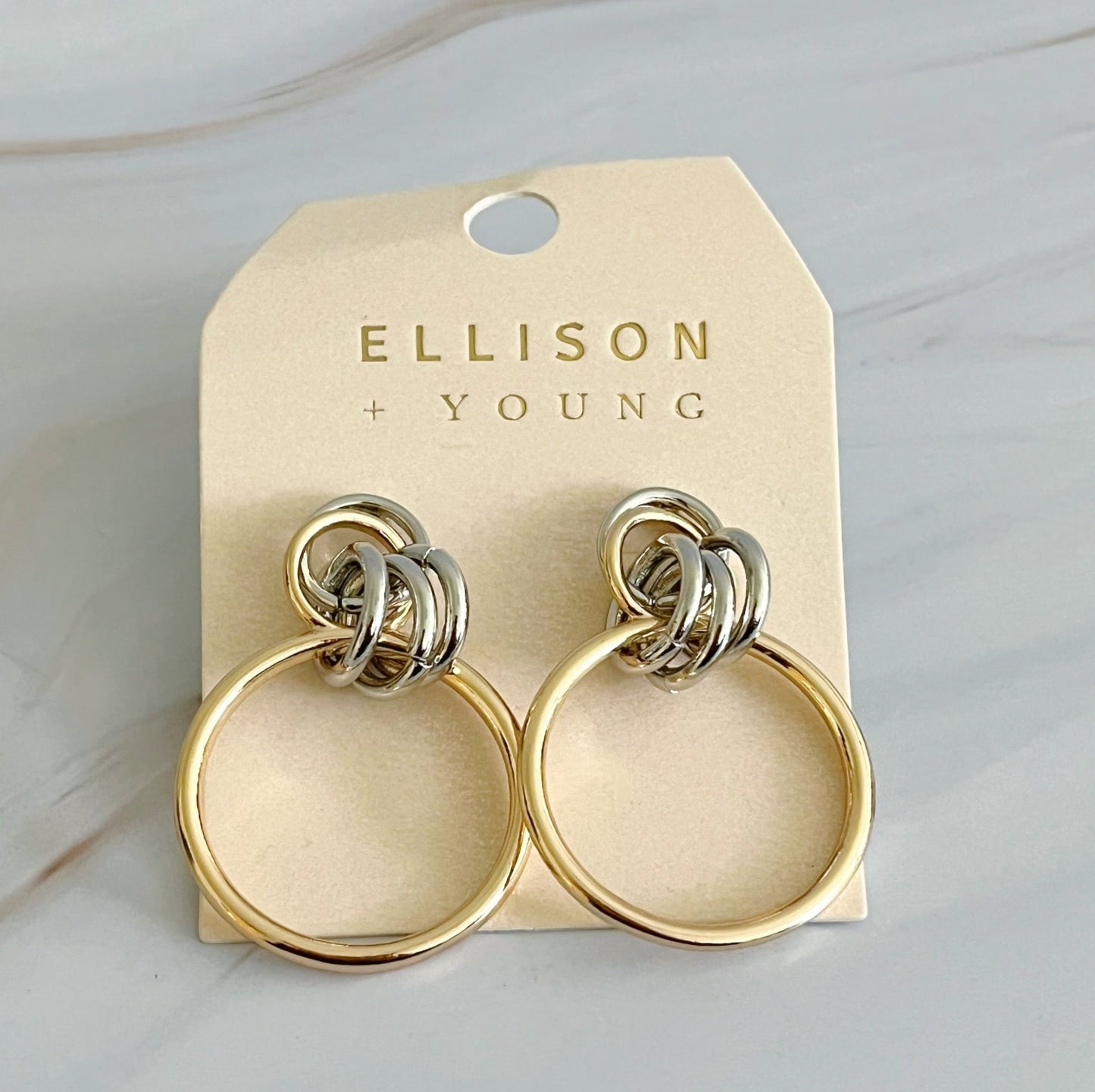Elegant gold hoop earrings with silver accents, 1.2" x 1.4", designed to enhance style and sophistication for any occasion.