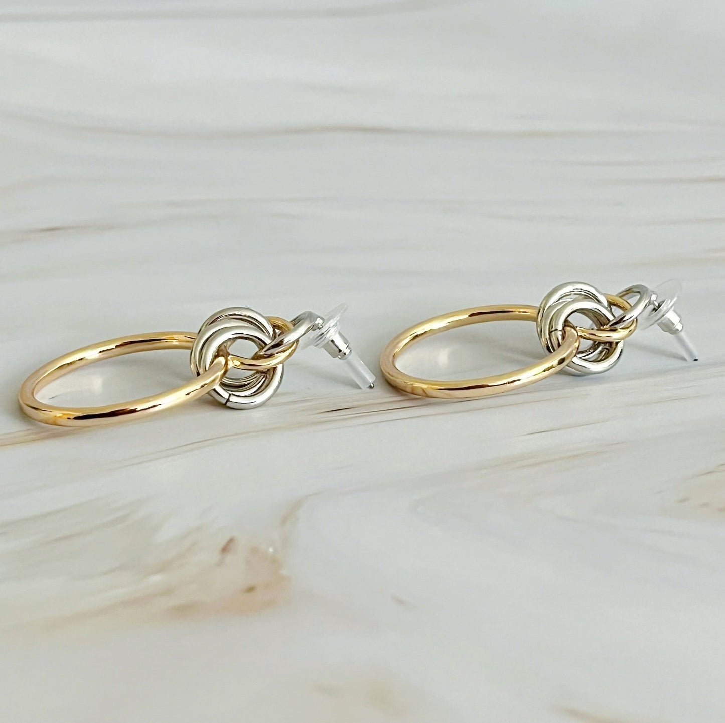 Gold and silver hoop earrings with intricate design, measuring 1.2" x 1.4", perfect for elevating any outfit.