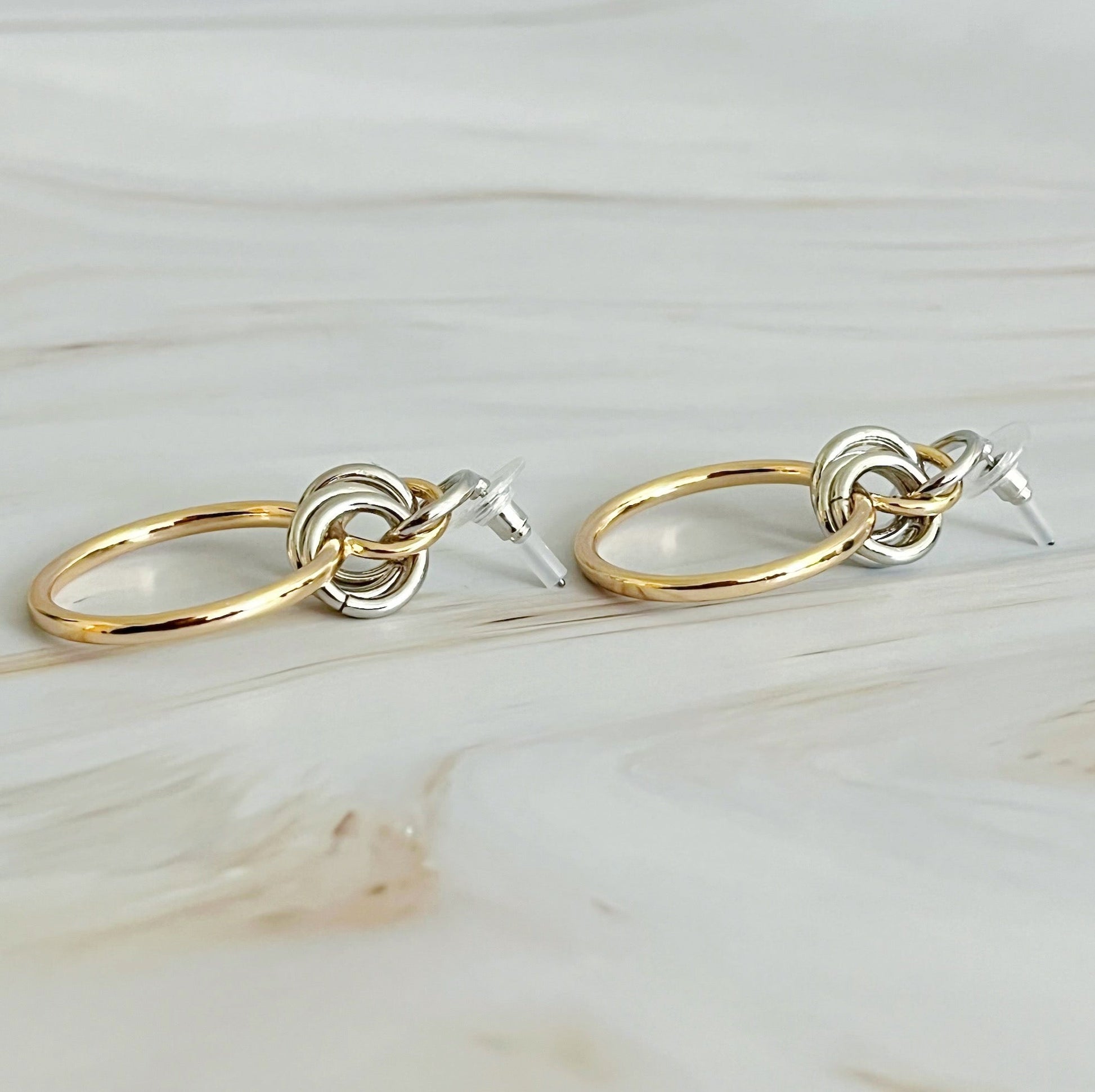 Gold and silver hoop earrings with intricate design, measuring 1.2" x 1.4", perfect for elevating any outfit.