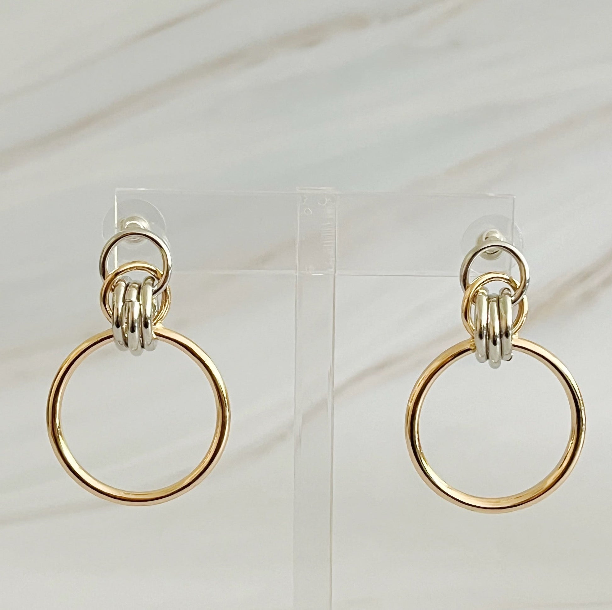 Unique two-tone gold and silver hoop earrings, 1.2" x 1.4",
crafted from plated alloy, ideal statement piece for any event.