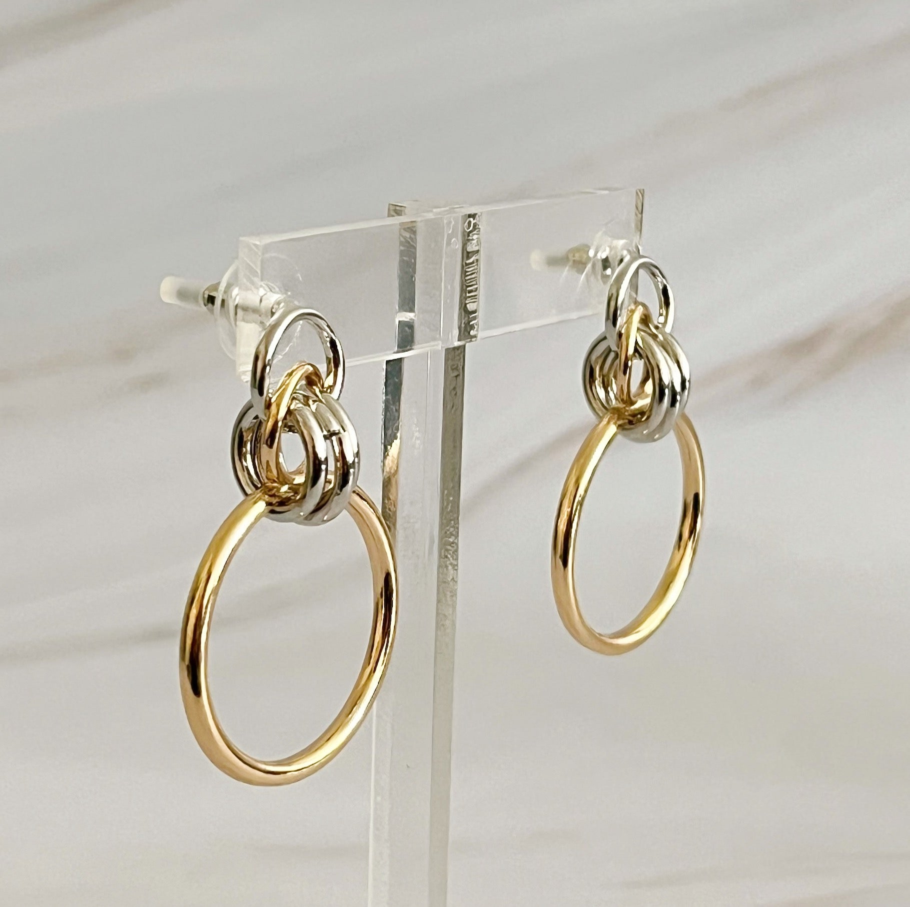 Elegant two-tone gold and silver hoop earrings, 1.2" x 1.4", made of plated alloy metal, perfect for elevating any outfit.