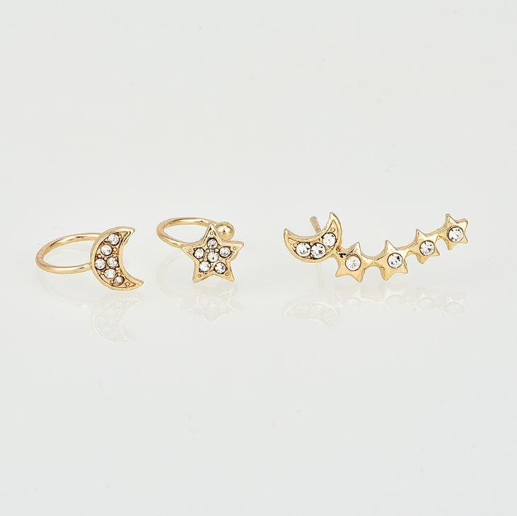 Three earrings showcasing stars and a moon, crafted for one ear with two cuffs and one crawler for a unique asymmetrical style.