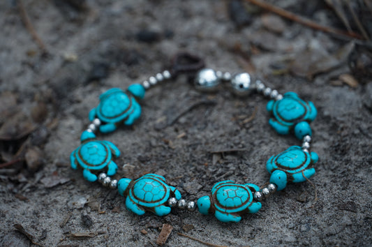 Handmade turquoise bracelet featuring silver beads and stones, secured with a hook, perfect for boho and beach themes