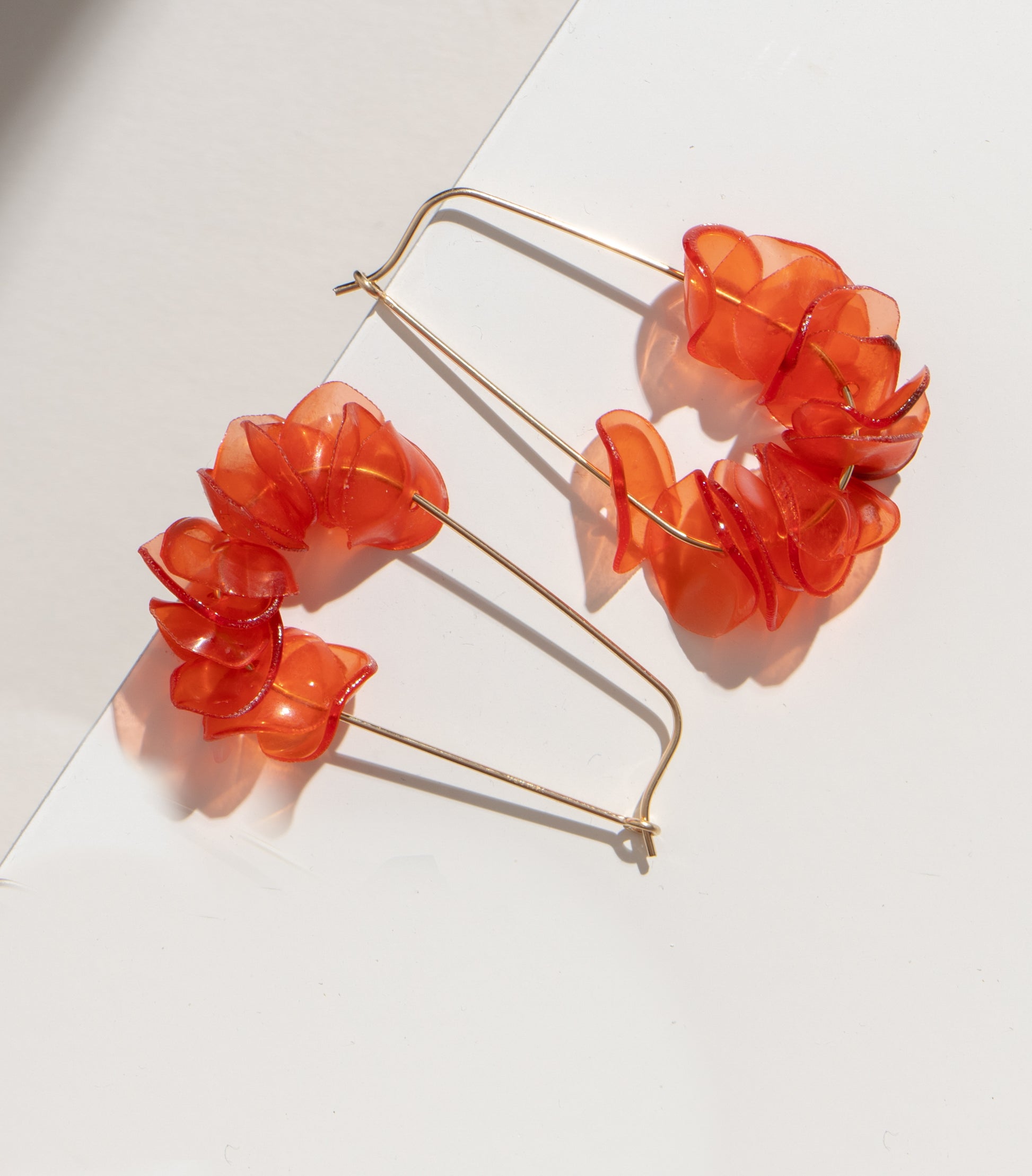 Handmade orange earrings with coral petals on a white background, featuring sustainable 14k gold filled drops.