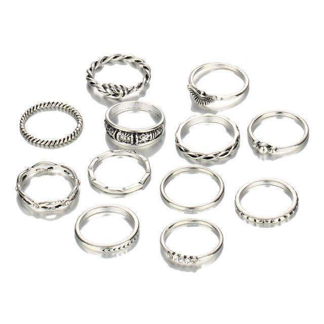 A set of 12 silver rings featuring various designs, made of zinc alloy and gemstones, with fixed sizes shown in the image.