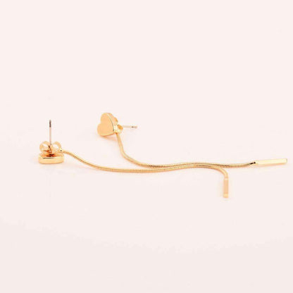 Gold heart-shaped drop earrings, measuring 8 cm, placed on a white surface. Made from alloy material.