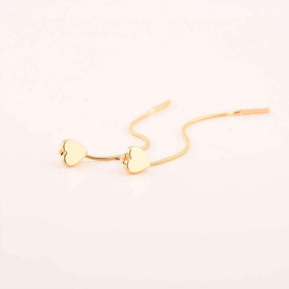 Two gold heart-shaped drop earrings, 8 cm long, displayed on a white surface. Made of alloy material