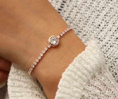 A woman showcases a rose gold bracelet featuring a diamond, adjustable length, made of zinc alloy and CZ.