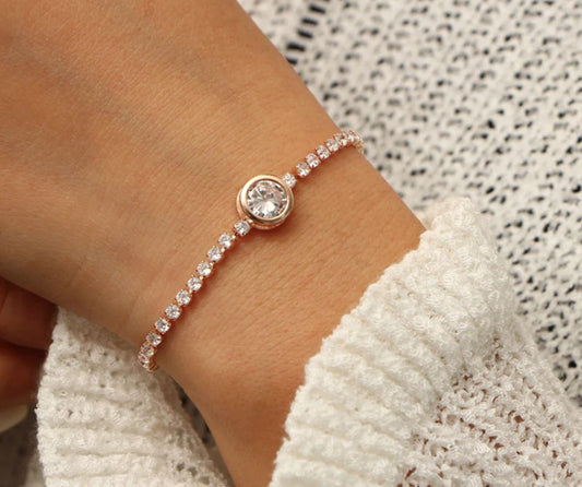 A woman showcases a rose gold bracelet featuring a diamond, adjustable length, made of zinc alloy and CZ.