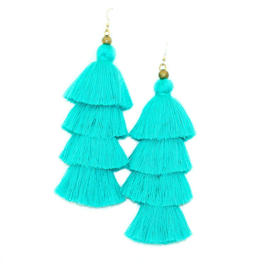 Vibrant turquoise tassel earrings featuring gold-filled ear wires, measuring 4.5" by 1.5", packaged in a pink box.