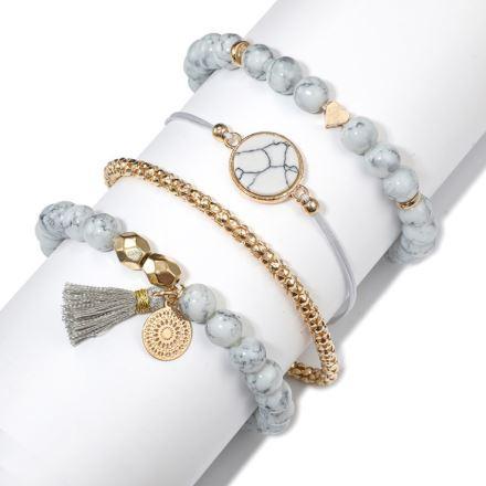 Set of four tassel bracelets featuring white marble and gold-plated elements, crafted from high-quality zinc alloy.
