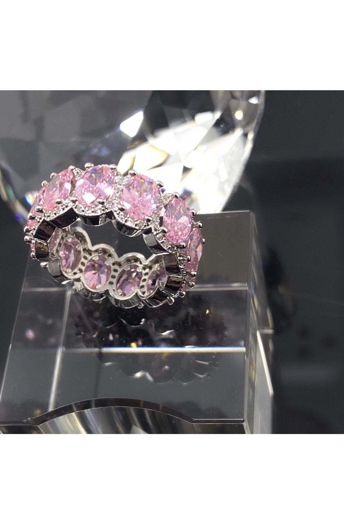 Elegant pink diamond eternity band crafted from polished 14K white gold, showcasing flawless VVS simulants.