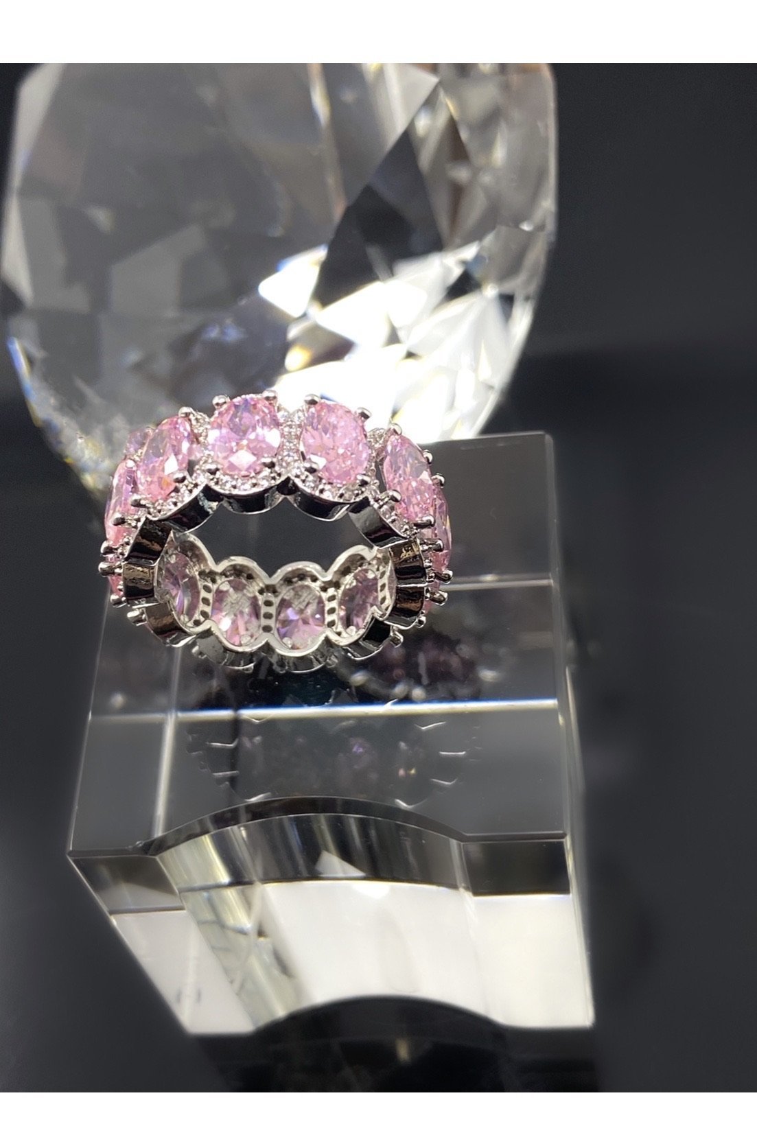 A stunning pink diamond eternity band made of high polished 14K white gold, adorned with flawless VVS simulants.