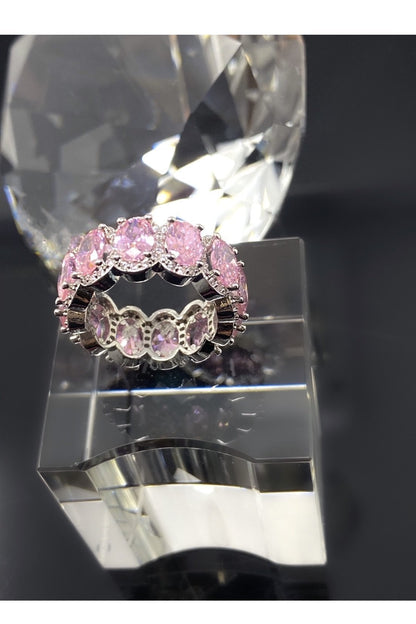 A stunning pink diamond eternity band made of high polished 14K white gold, adorned with flawless VVS simulants.