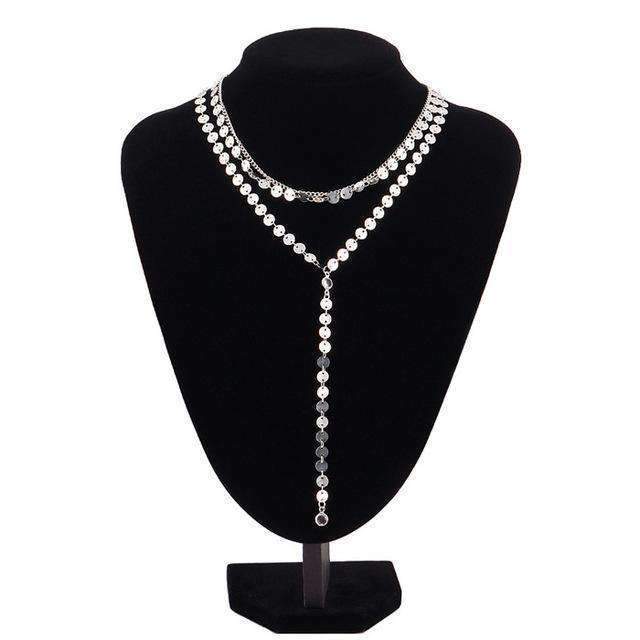 A three-layer necklace featuring a silver disc pendant and two rhinestone accents, with a 15.75" chain and extender