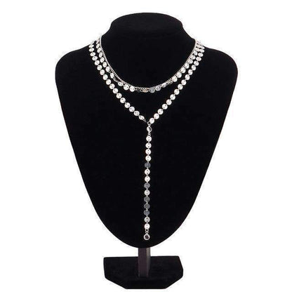 A three-layer necklace featuring a silver disc pendant and two rhinestone accents, with a 15.75" chain and extender